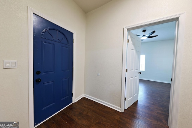 entrance foyer featuring ceiling fan, baseboards, and dark wood-style flooring