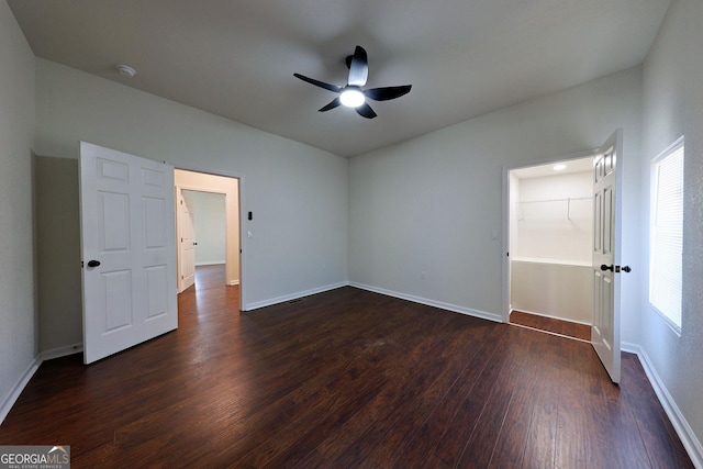 unfurnished bedroom with ceiling fan, dark wood-type flooring, and baseboards