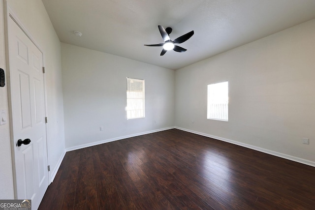 unfurnished bedroom with baseboards, dark wood finished floors, and a ceiling fan