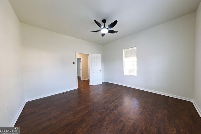 unfurnished bedroom with dark wood-style floors, ceiling fan, visible vents, and baseboards