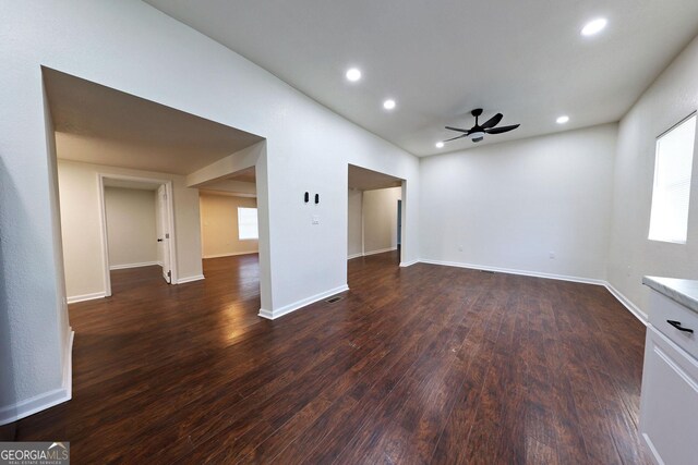 unfurnished room with a ceiling fan, baseboards, dark wood-type flooring, and recessed lighting