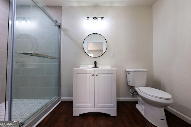 full bath with toilet, a shower stall, baseboards, and wood finished floors