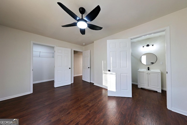 unfurnished bedroom with dark wood-type flooring, ceiling fan, and baseboards