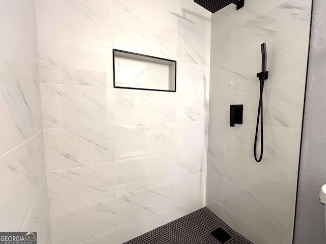 full bath with a tile shower