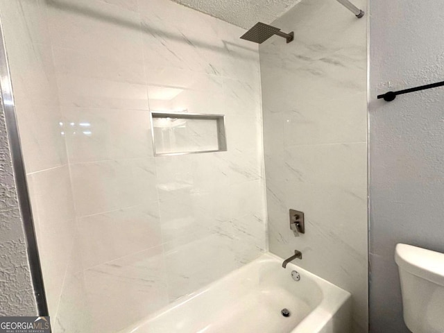 full bathroom featuring a textured ceiling, a textured wall, bathing tub / shower combination, and toilet