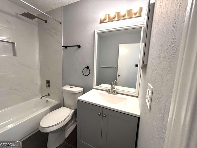 bathroom featuring a textured wall, toilet, vanity, a textured ceiling, and  shower combination