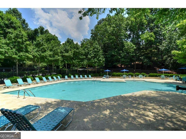 pool featuring a patio area and fence