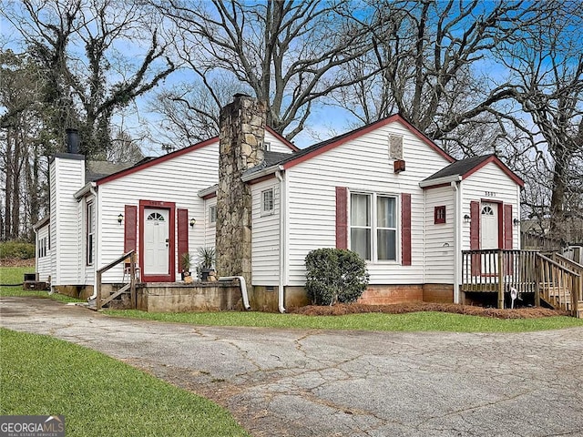 bungalow-style home with a chimney