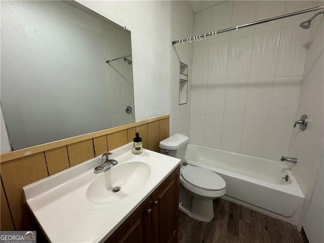 bathroom with tub / shower combination, vanity, toilet, and wood finished floors