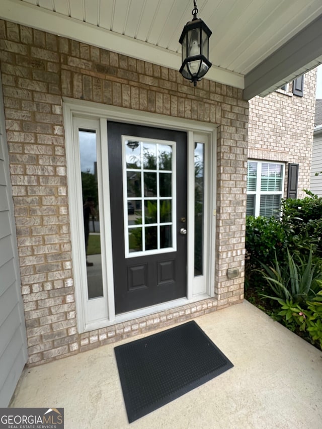 property entrance with brick siding