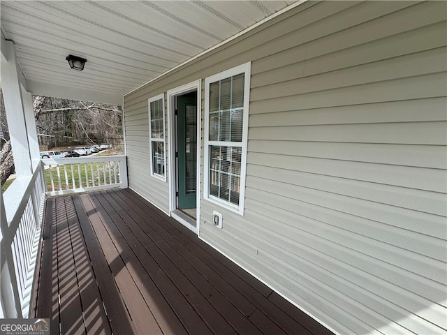 wooden terrace featuring covered porch