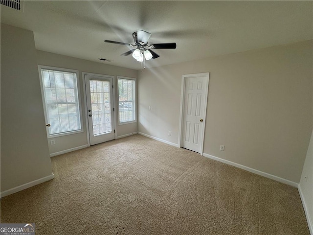 empty room with visible vents and baseboards