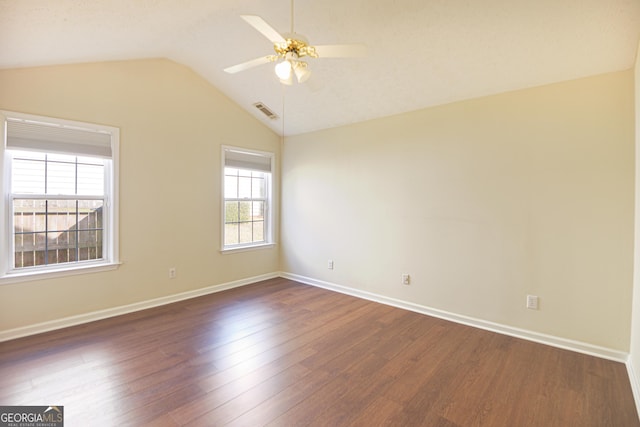 unfurnished room featuring baseboards, visible vents, a ceiling fan, lofted ceiling, and dark wood-style floors