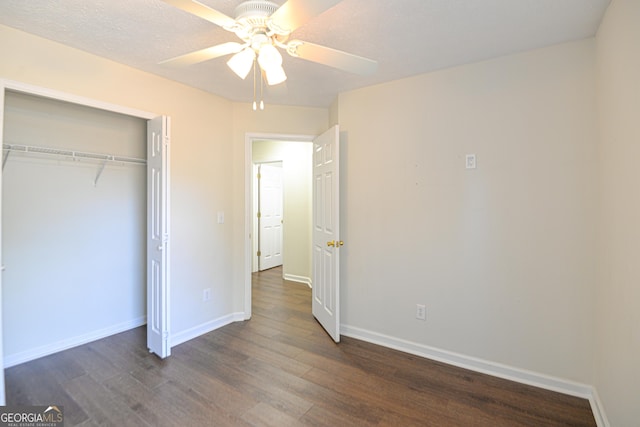 unfurnished bedroom featuring a closet, baseboards, and wood finished floors