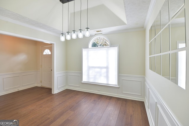 unfurnished dining area with dark wood-style floors, a healthy amount of sunlight, ornamental molding, and visible vents