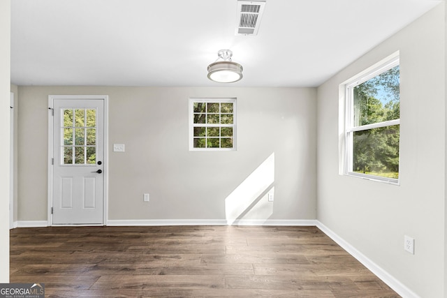 interior space with plenty of natural light, wood finished floors, and visible vents