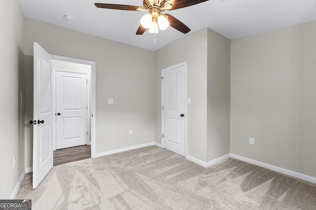 unfurnished bedroom featuring carpet flooring, a ceiling fan, and baseboards