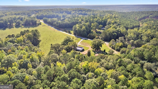 birds eye view of property featuring a view of trees