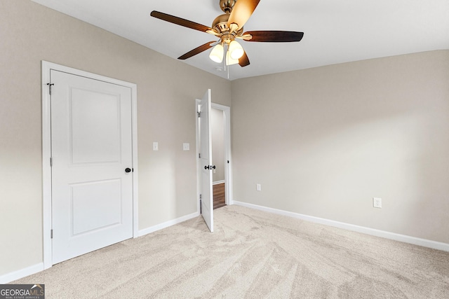 unfurnished bedroom featuring ceiling fan, baseboards, and light colored carpet