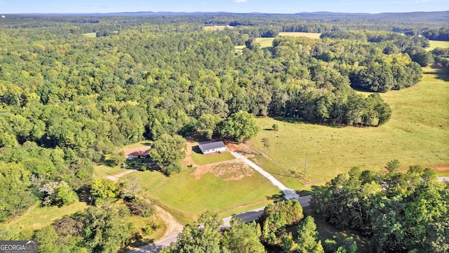 drone / aerial view with a wooded view