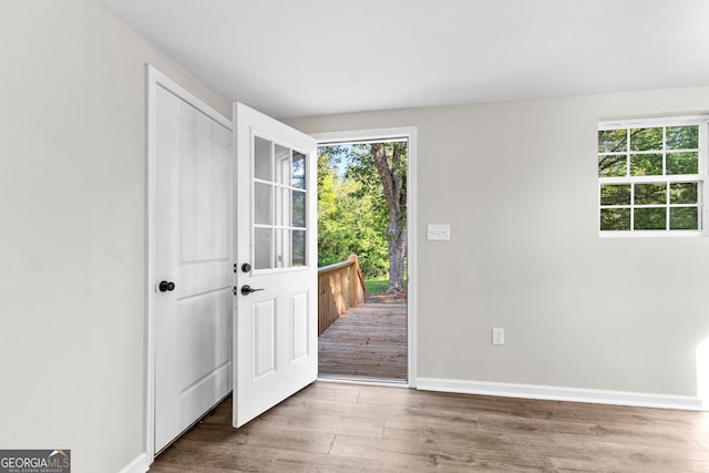 entrance foyer featuring wood finished floors and baseboards