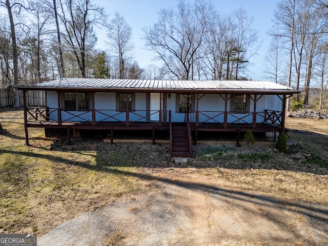 view of front of home featuring covered porch and metal roof