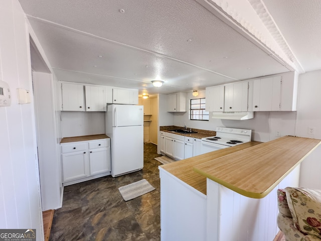 kitchen featuring white appliances, white cabinets, a peninsula, under cabinet range hood, and a sink