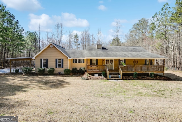 view of front of home featuring a porch, a chimney, and a shingled roof