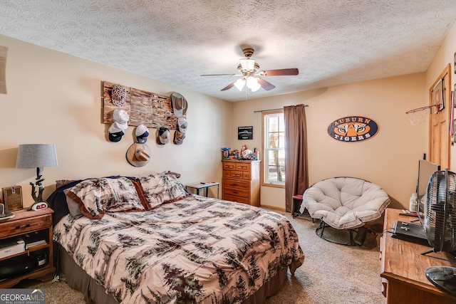 carpeted bedroom featuring ceiling fan and a textured ceiling