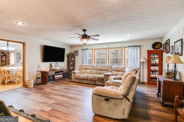 living room with recessed lighting, ceiling fan, a textured ceiling, and wood finished floors