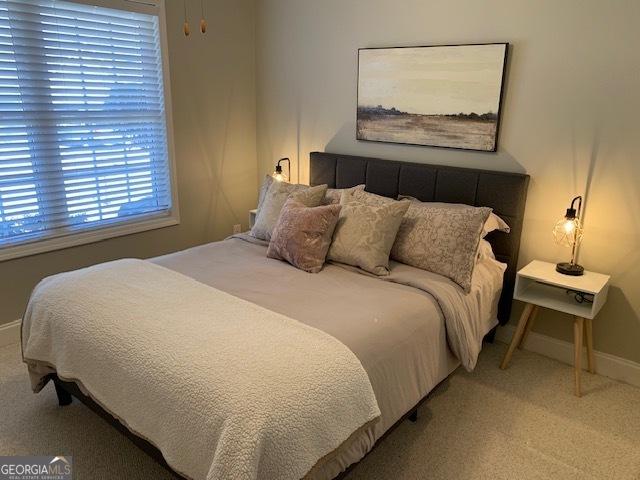 carpeted bedroom featuring baseboards