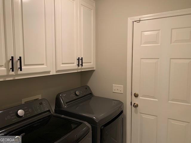 laundry area with cabinet space and washing machine and dryer