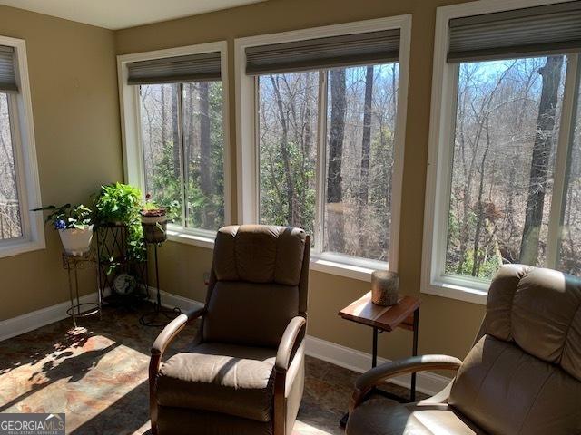 living area featuring baseboards