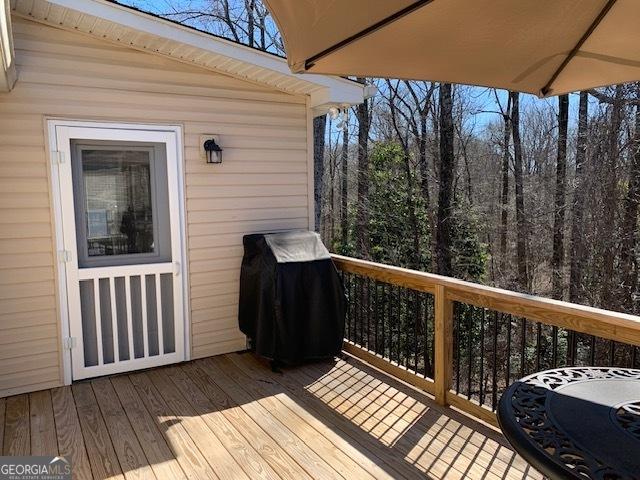 wooden deck with a grill