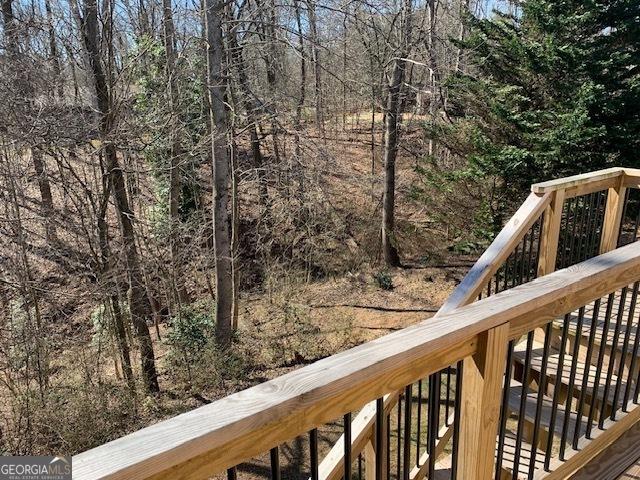 wooden deck featuring a wooded view