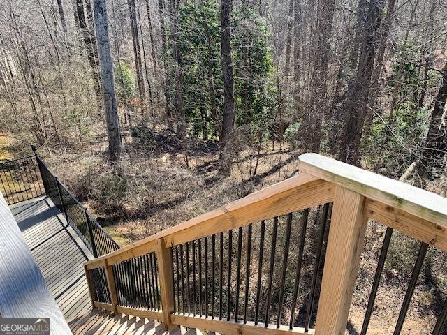 deck featuring a forest view