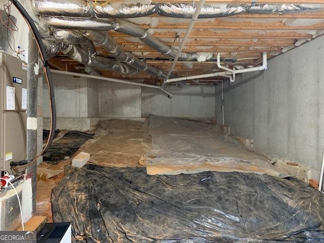 below grade area with heating unit and crawl space