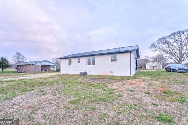 rear view of property featuring crawl space, metal roof, and central AC