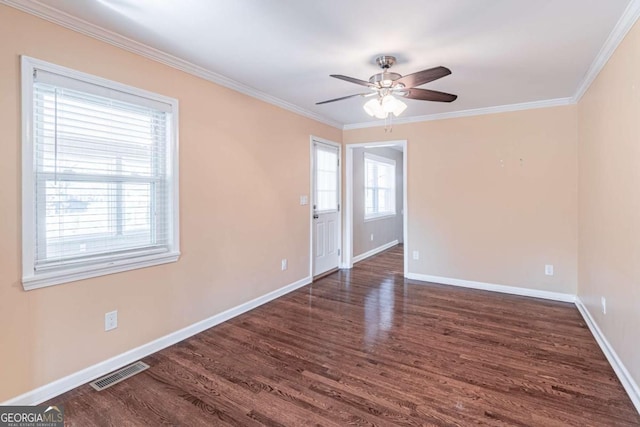 unfurnished room featuring wood finished floors, visible vents, and baseboards