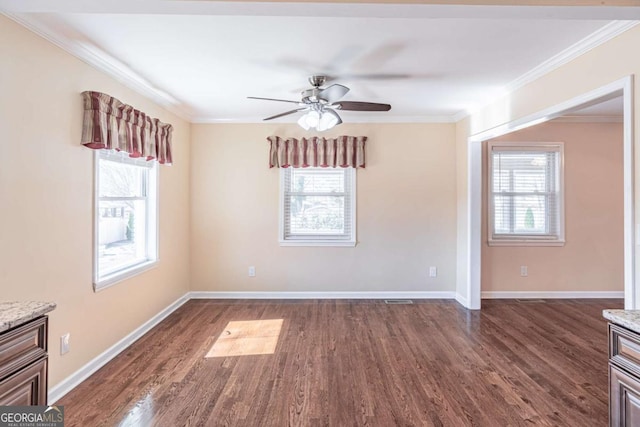 empty room featuring baseboards, visible vents, dark wood finished floors, ceiling fan, and ornamental molding