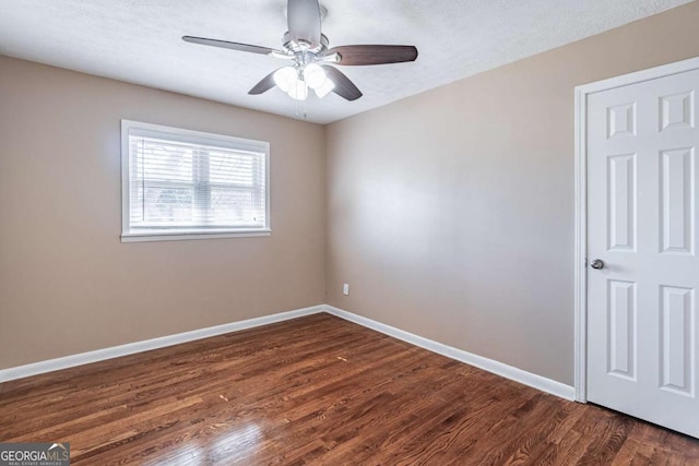 unfurnished bedroom with a ceiling fan, a textured ceiling, baseboards, and dark wood-style flooring