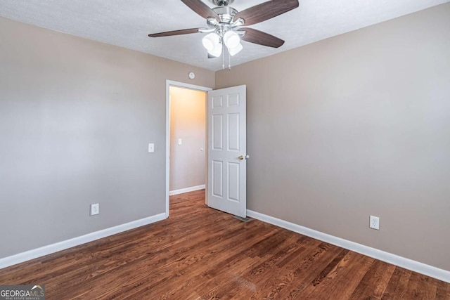 unfurnished room featuring ceiling fan, baseboards, and wood finished floors