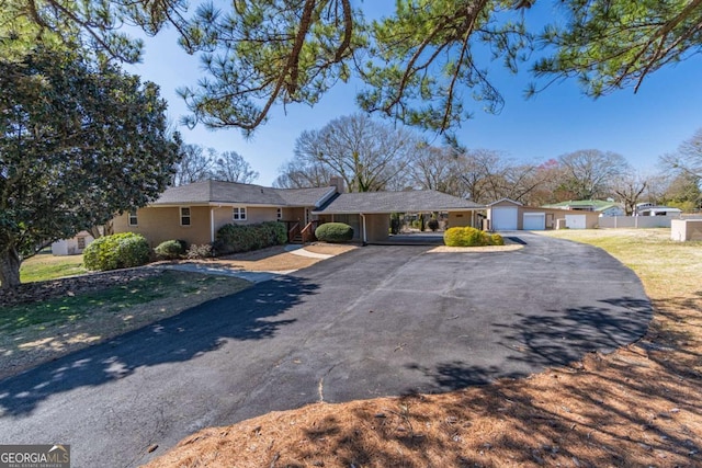 ranch-style house with a garage and fence