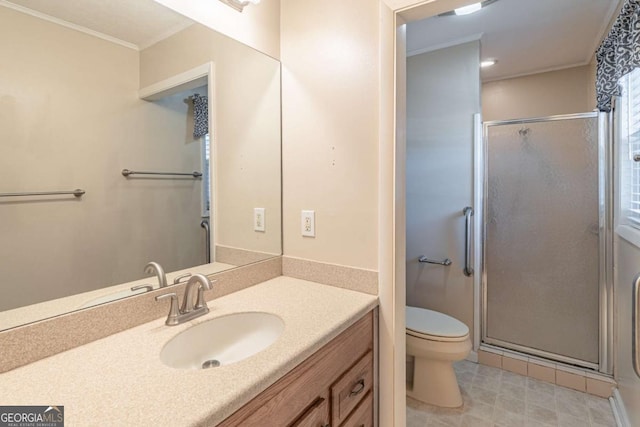 full bathroom featuring vanity, ornamental molding, a shower stall, and toilet