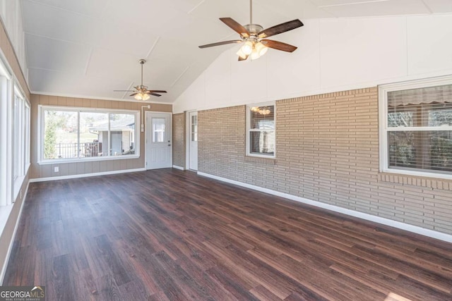 unfurnished sunroom featuring vaulted ceiling and a ceiling fan