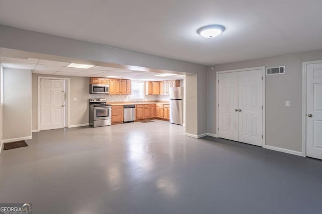 kitchen with baseboards, visible vents, appliances with stainless steel finishes, and concrete flooring