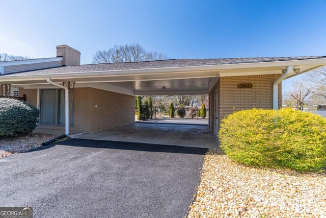 view of parking with a carport and driveway