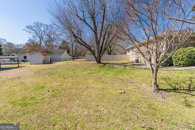 view of yard with an outbuilding and fence