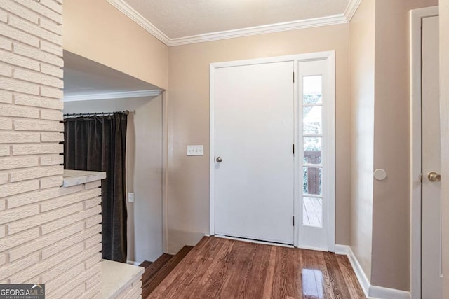 entrance foyer with baseboards, crown molding, and wood finished floors