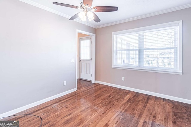 unfurnished room with ceiling fan, ornamental molding, wood finished floors, and baseboards